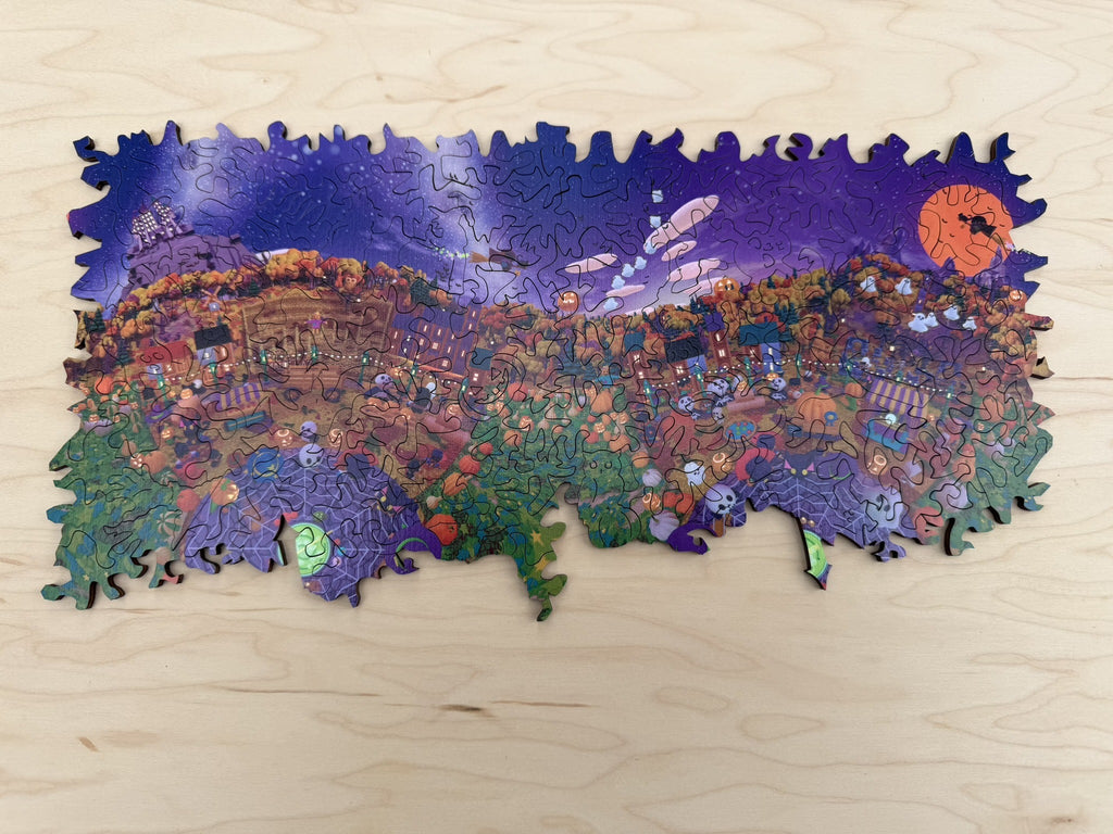Festival at Shiver Falls assembled as a long panorama: the town and pumpkin patches along the bottom, purple night sky and orange moon above