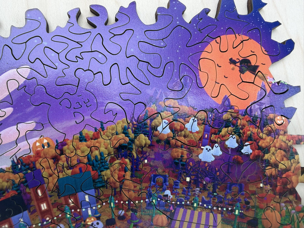 Close-up of the orange moon with a flying witch and a skull-and-crossbones whimsy piece cut into the purple sky