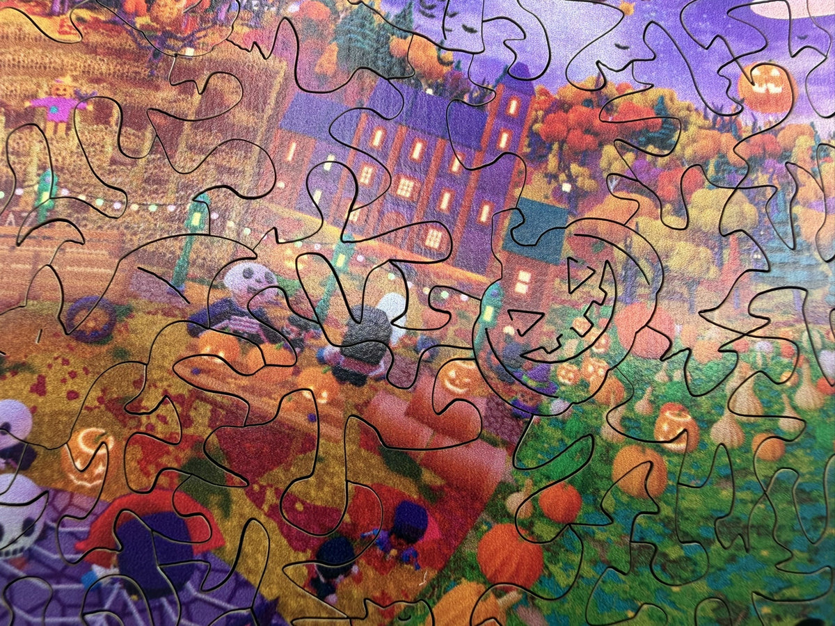 Close-up of the festival square with a jack-o'-lantern whimsy piece cut among the buildings and pumpkins